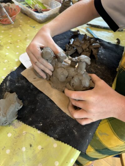 Children's hands on clay